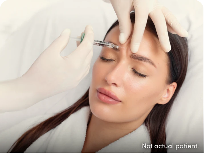 Woman getting an injection in frown lines